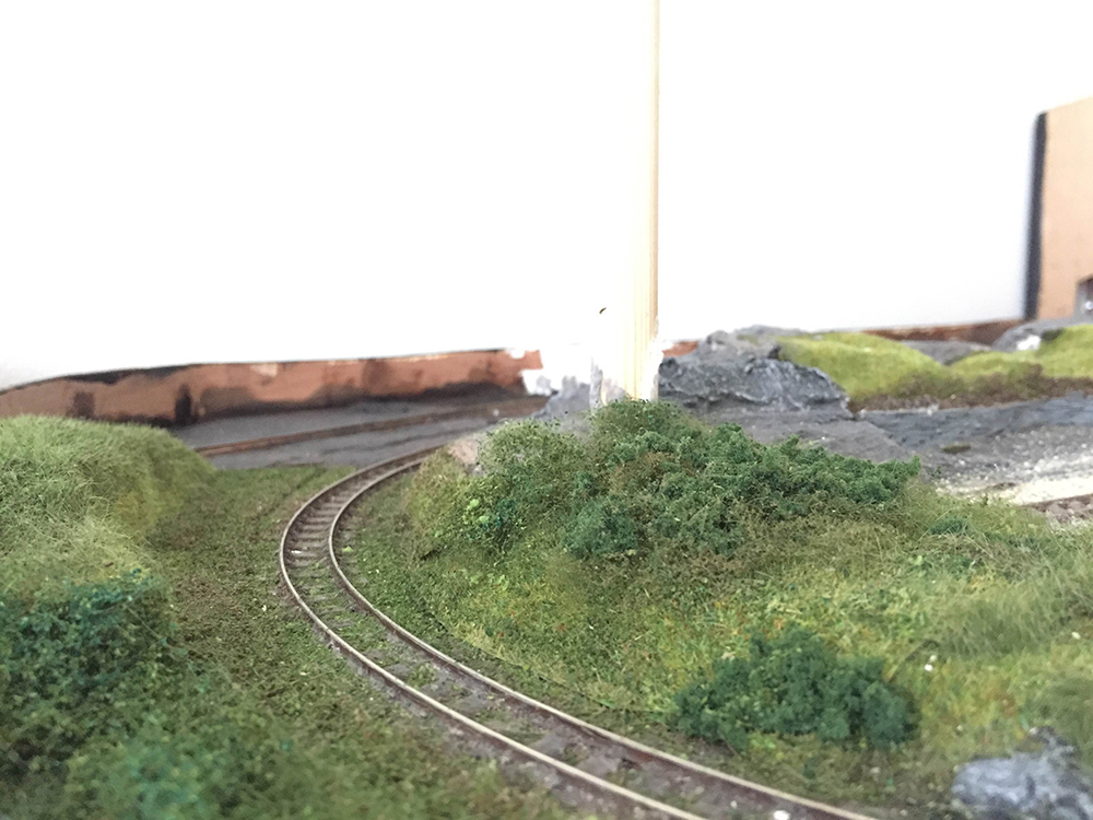 Following along the line around the bend, we have an area of heavy foliage waiting for tree/s to finish, the dark area in the rear to the left is where the engine shed goes
